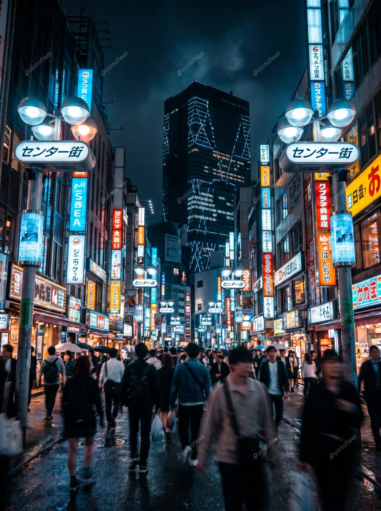 Crowded Shibuya street at night with glowing neon signs