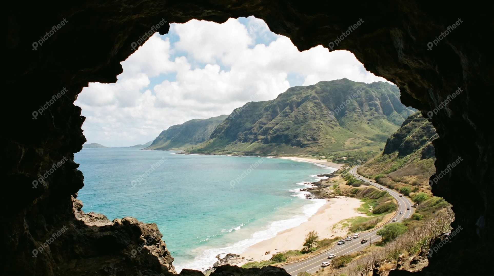 Scenic coastal view through a rock cave opening in Hawaii