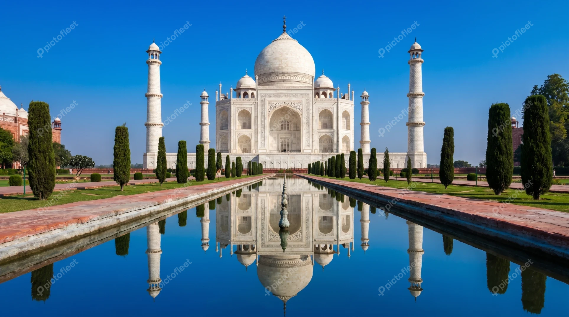 Taj Mahal with reflection in water under blue sky